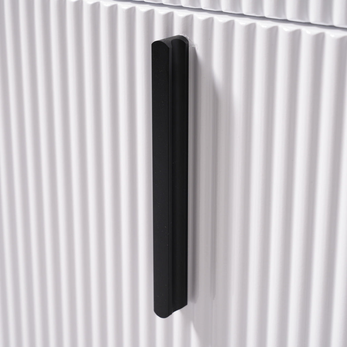 Vanity cabinet handle in black metal with rounded ends on a white fluted panel on Tampa Home & Garden Store