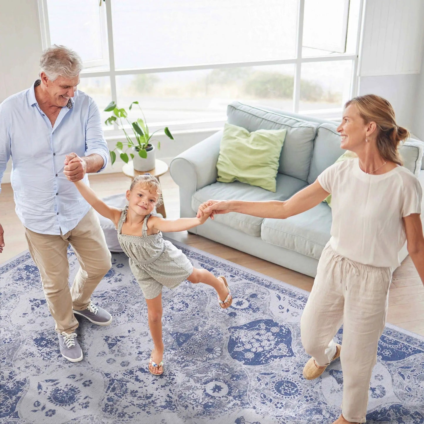 Maval Area Rug blue floral pattern on living room floor with family Tampa Garden Store on Tampa Home & Garden Store