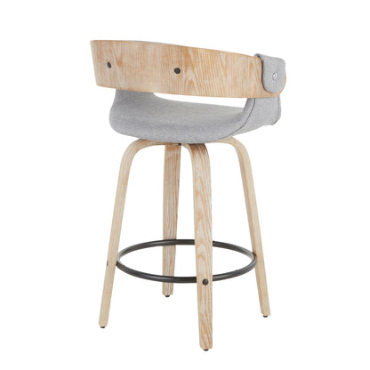 Farmhouse counter stool with cushioned gray seat, whitewashed legs and black metal footring on Tampa Home & Garden Store