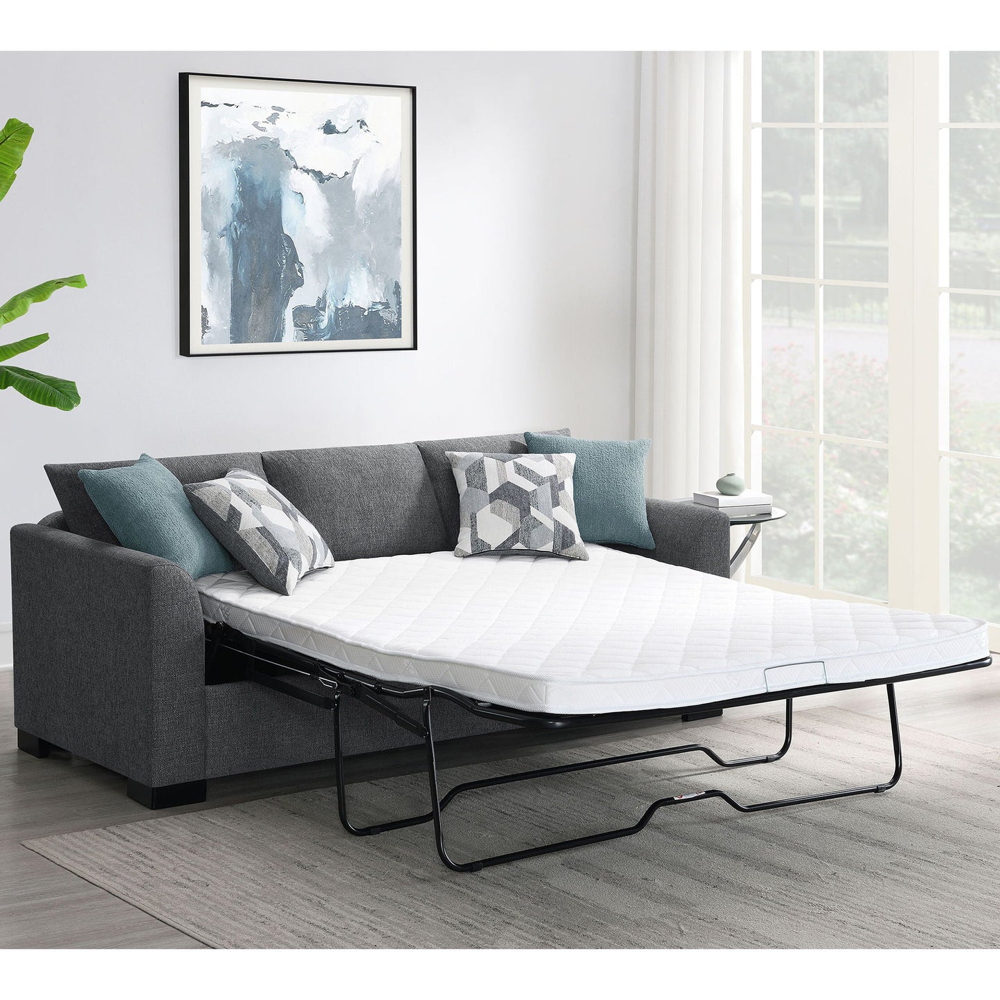 Pacheco Sleeper Sectional Chaise Sofa in charcoal gray fabric with pull-out bed and teal pillows on Tampa Home & Garden Store