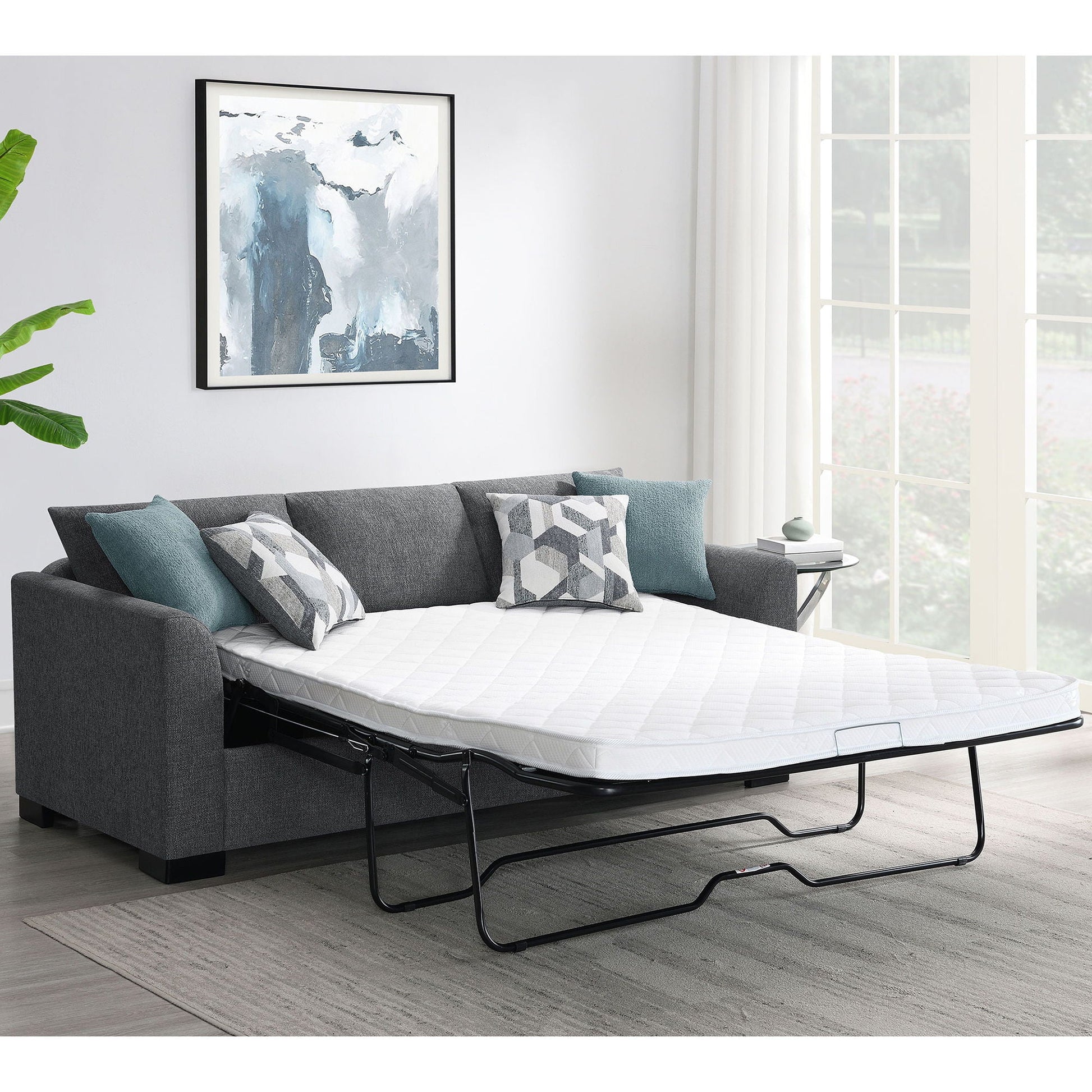 Pacheco Sleeper Sectional Chaise Sofa in charcoal gray fabric with pull-out bed and teal pillows on Tampa Home & Garden Store