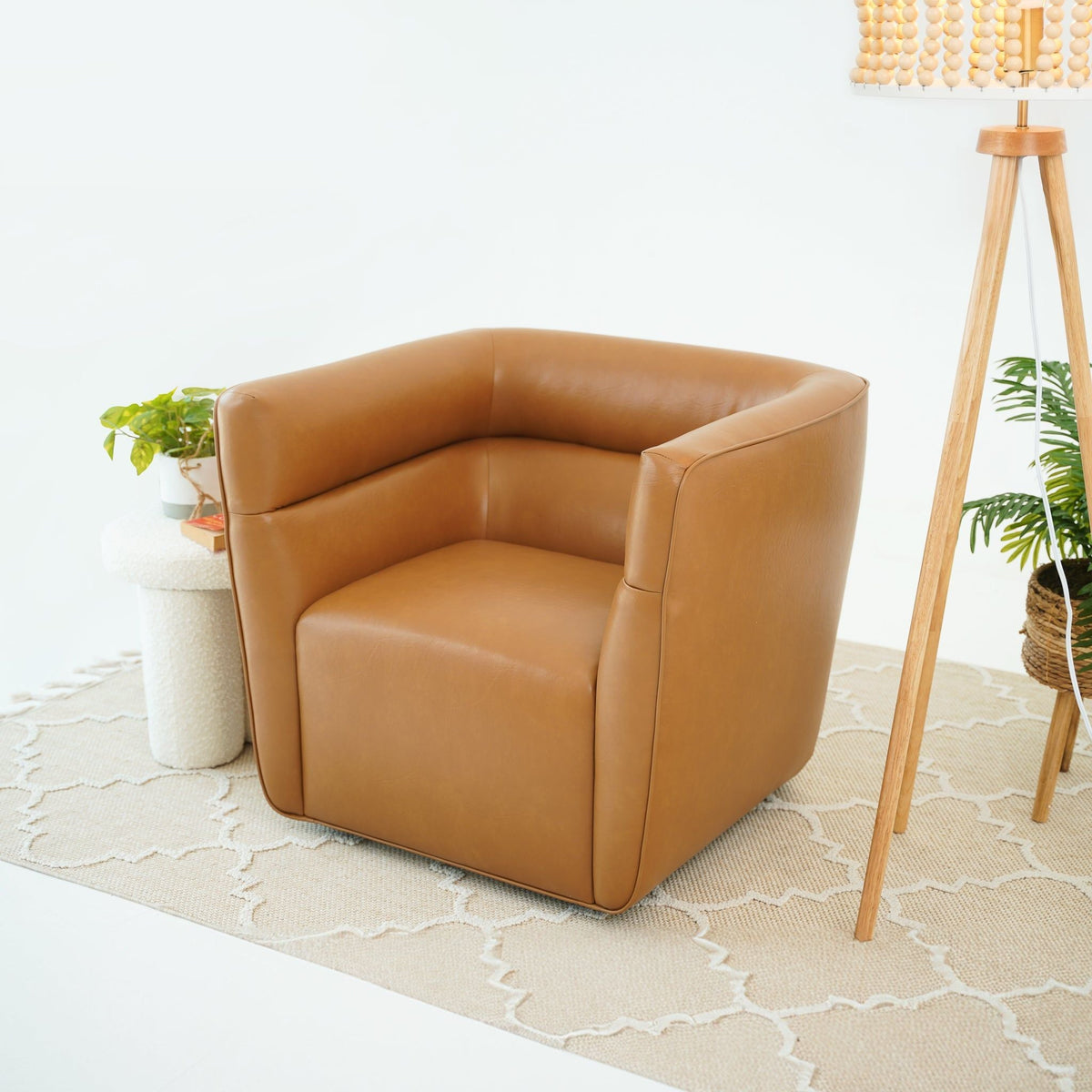 Tan genuine leather swivel chair armchair by HouseOfZazla in a bright room on Tampa Home & Garden Store