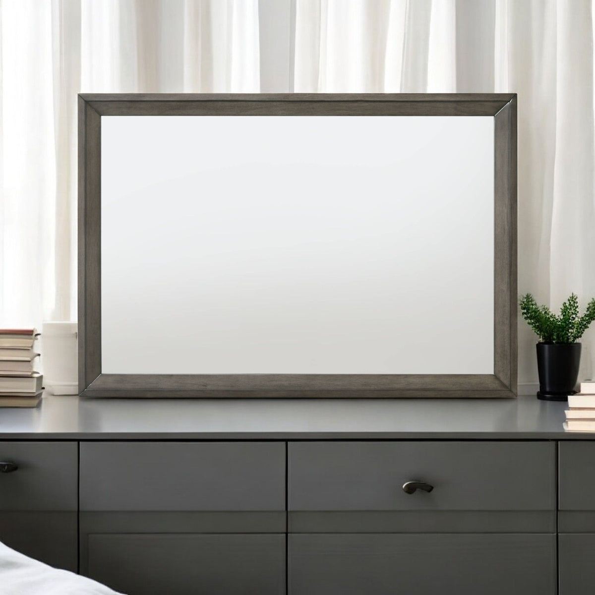 Escher Mirror with gray oak frame, rectangular mirror on a dresser with books and plant on Tampa Home & Garden Store