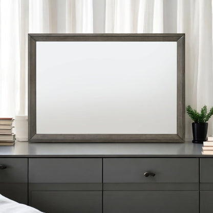 Escher Mirror with gray oak frame, rectangular mirror on a dresser with books and plant on Tampa Home & Garden Store