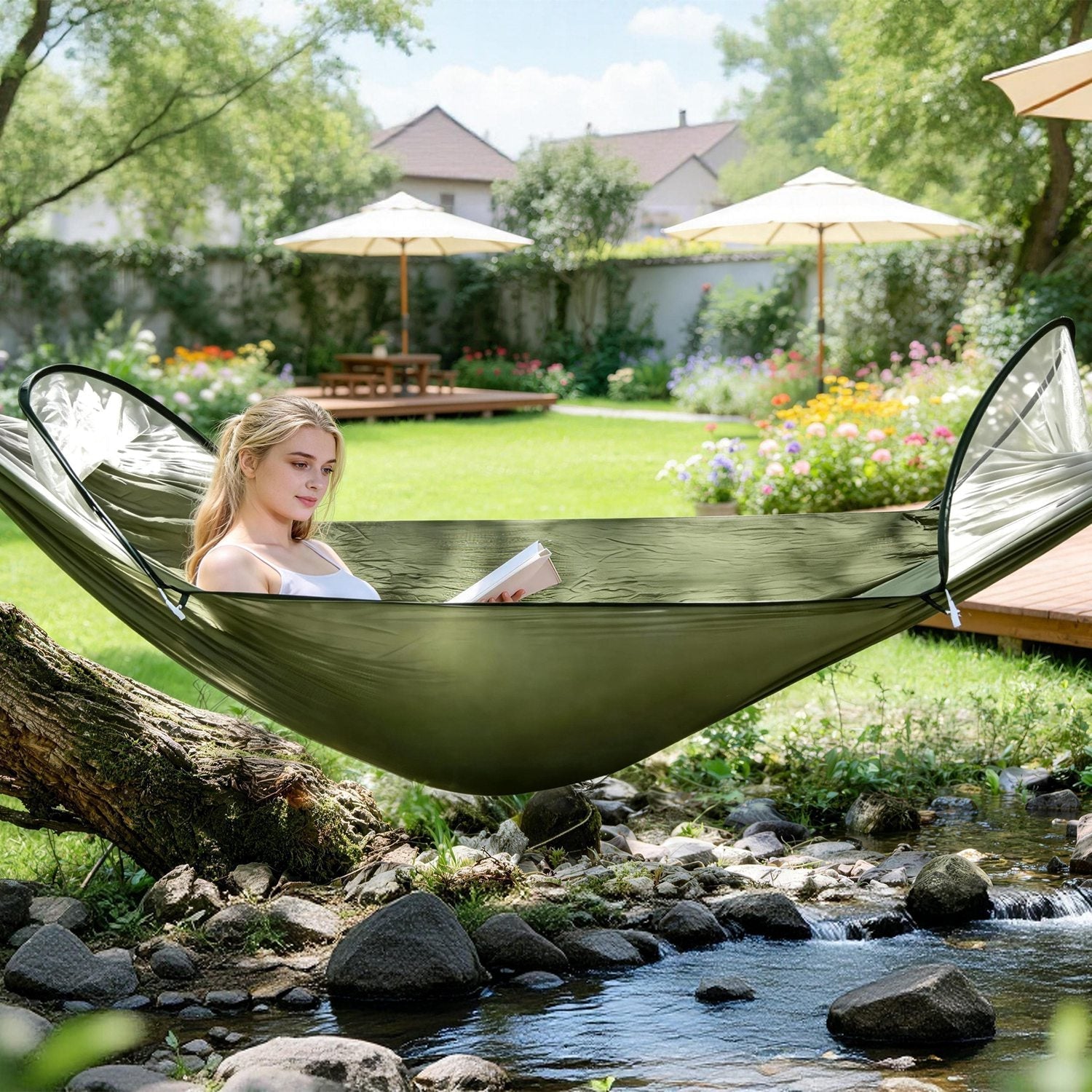 Camping hammock in olive green fabric, person reading in a garden beside a stream on Tampa Home & Garden Store