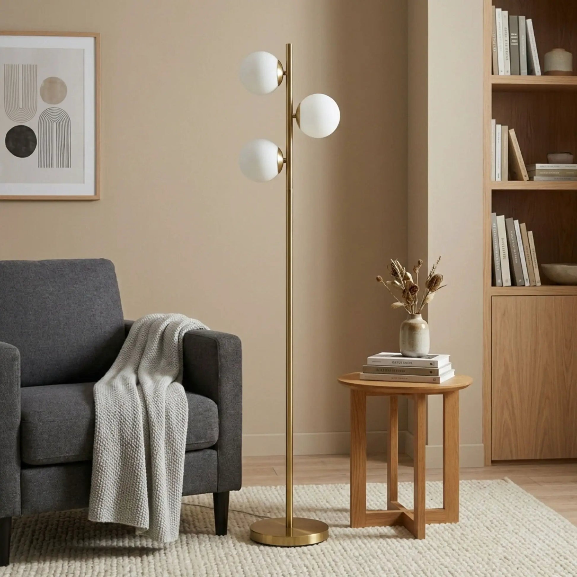 Floor lamp with three frosted opal globe shades on a brass gold stem and circular base on Tampa Home & Garden Store