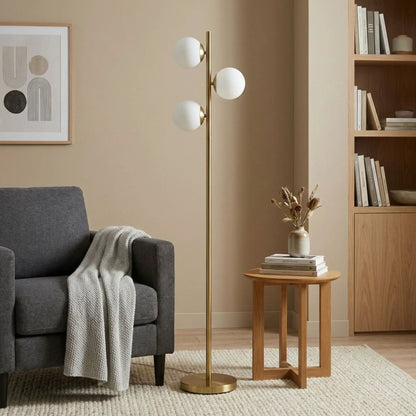 Floor lamp with three frosted opal globe shades on a brass gold stem and circular base on Tampa Home & Garden Store
