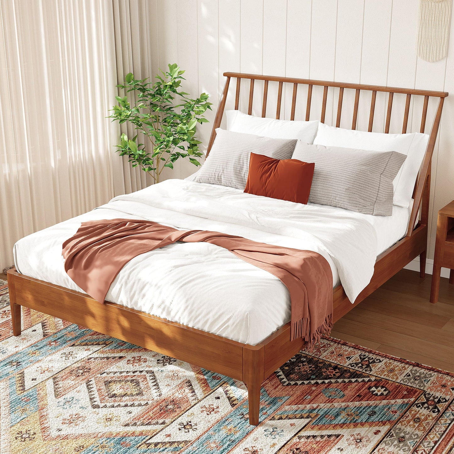 Bohemian platform bed with tall wooden headboard, white bedding and rust accent pillows on Tampa Home & Garden Store