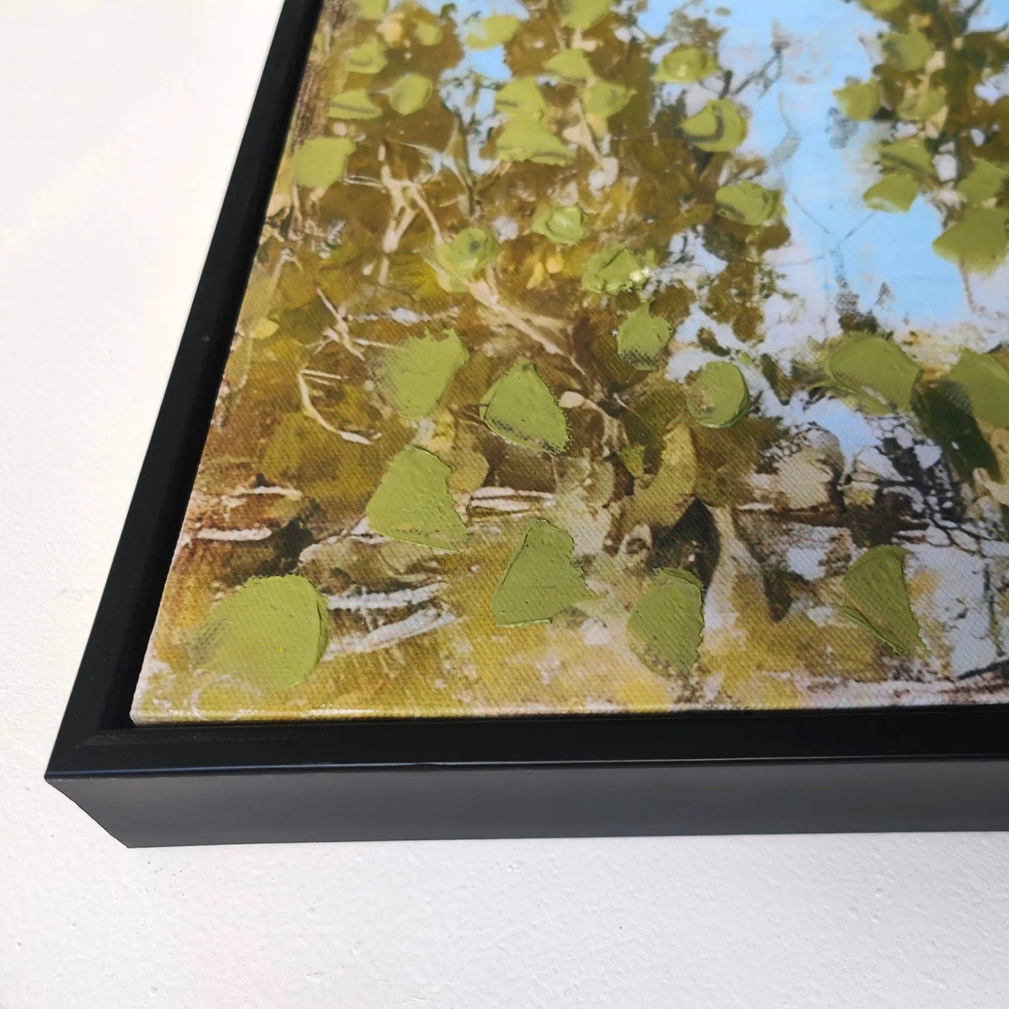 Framed canvas wall art of a field with wildflowers and trees, blue sky on Tampa Home & Garden Store
