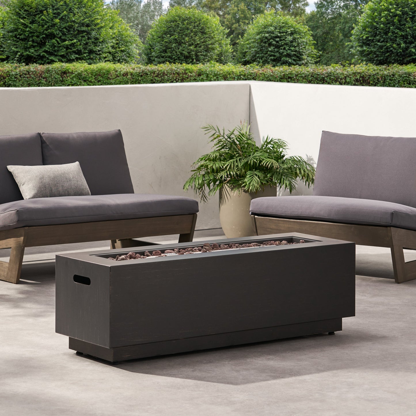 Modern Dark Grey Outdoor Iron Propane Fire Pit by HouseOfZazla with lava rocks and lounge chairs on Tampa Home & Garden Store