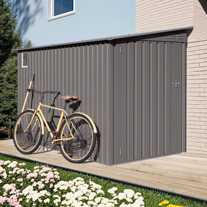Gray lean-to storage shed with windows and sloped roof beside wall, yellow bike in front on Tampa Home & Garden Store