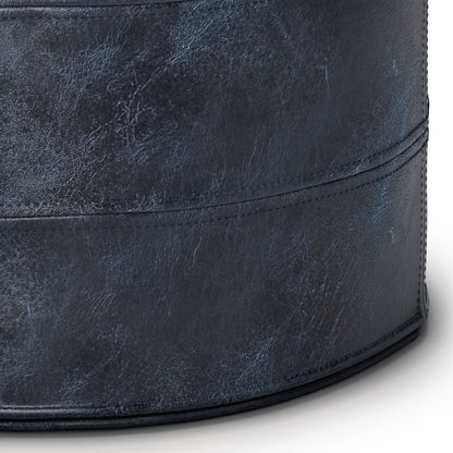 Handcrafted round pouf in distressed navy leather with visible stitching on Tampa Home & Garden Store