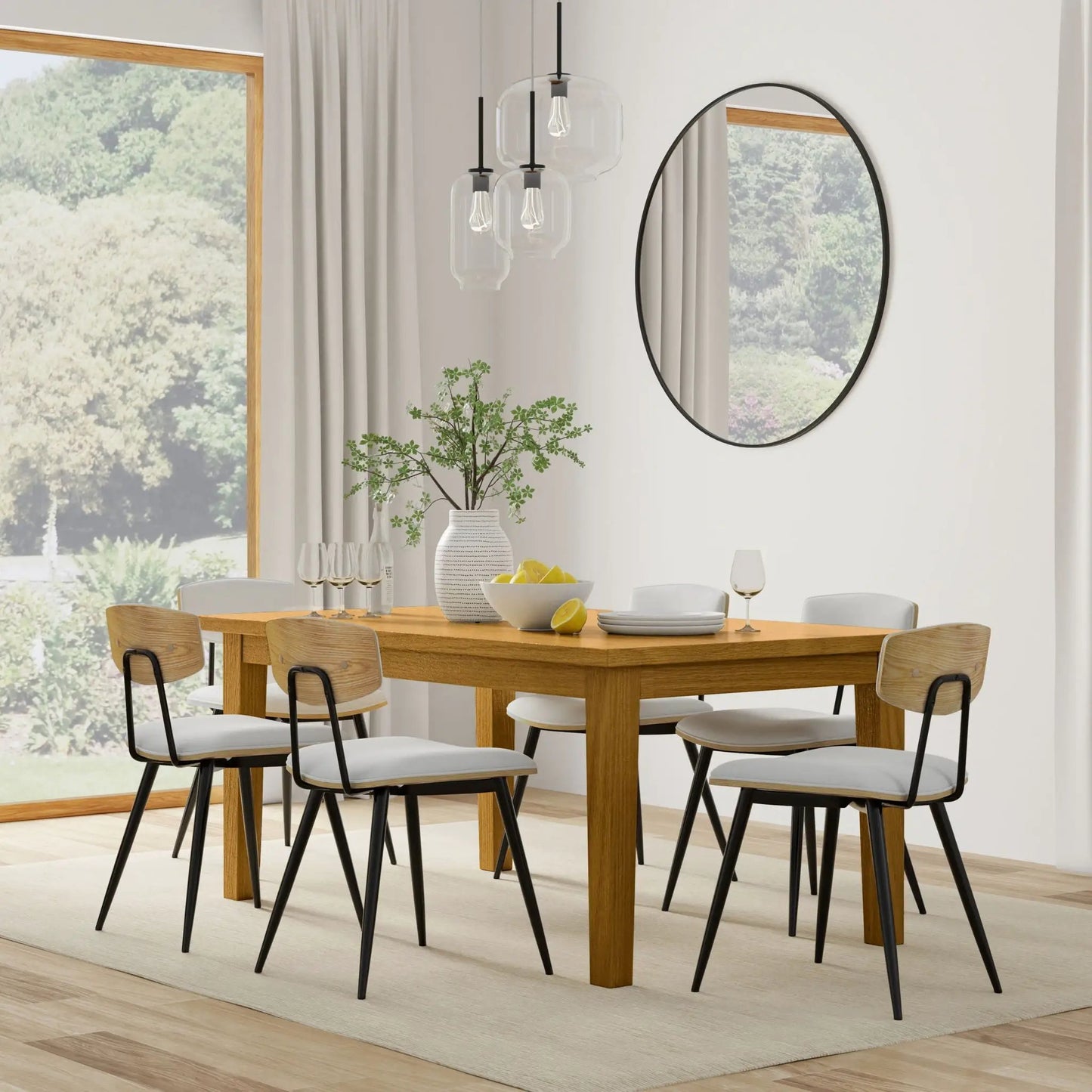 Eastwood handcrafted dining table in warm oak with light wood chairs and black metal legs on Tampa Home & Garden Store