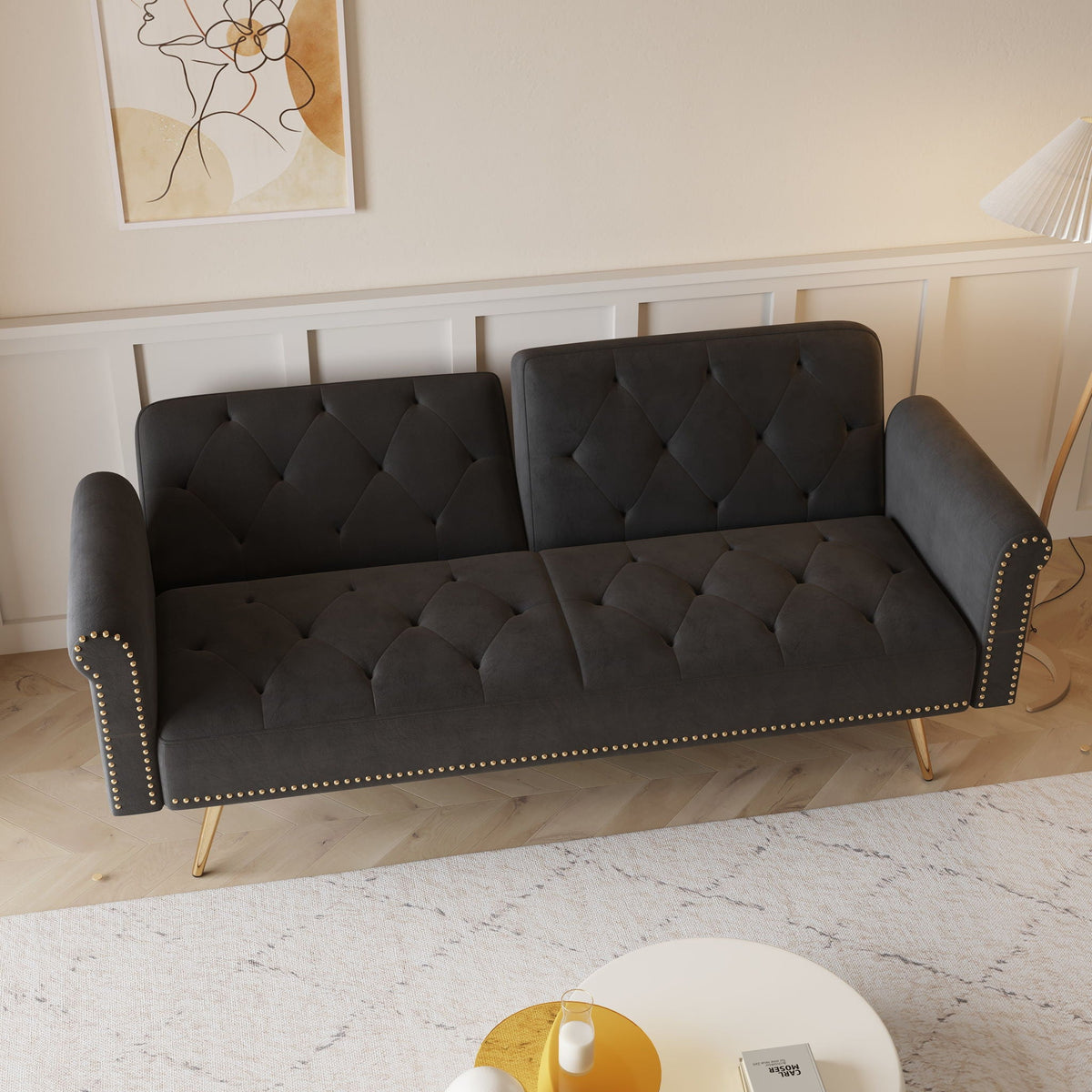 Velvet sofa bed in charcoal gray with tufted cushions, nailhead trim, and matching pillow on Tampa Home & Garden Store