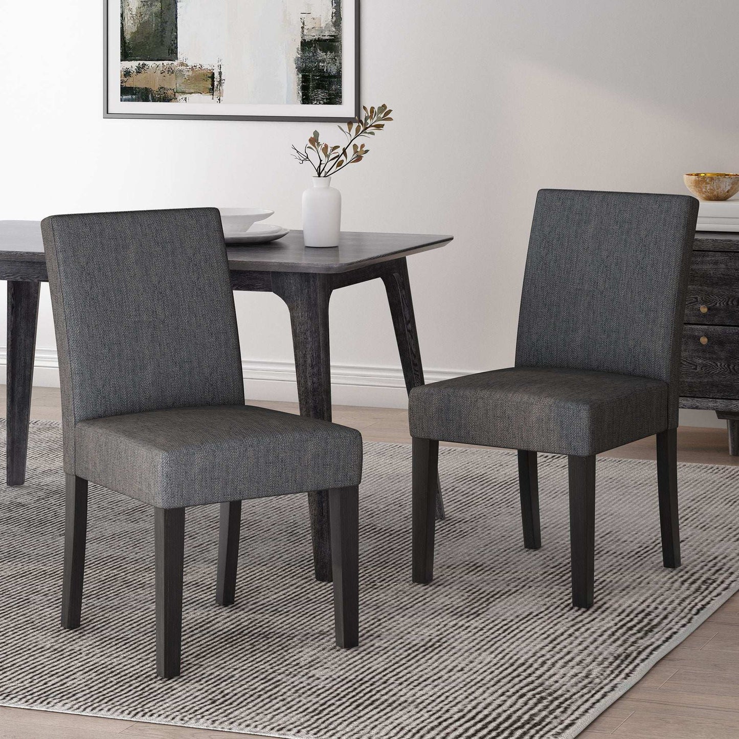 Contemporary dining chairs set with gray upholstered seats and tapered dark wood legs on Tampa Home & Garden Store