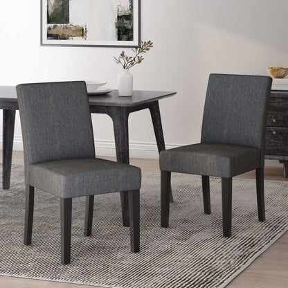 Contemporary dining chairs set with gray upholstered seats and tapered dark wood legs on Tampa Home & Garden Store