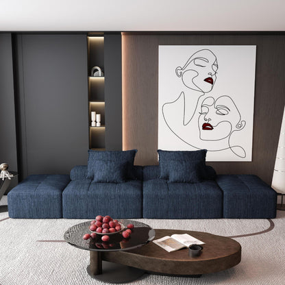 Modern oversized DIY modular sectional sofa in navy fabric with pillows against dark wood wall on Tampa Home & Garden Store