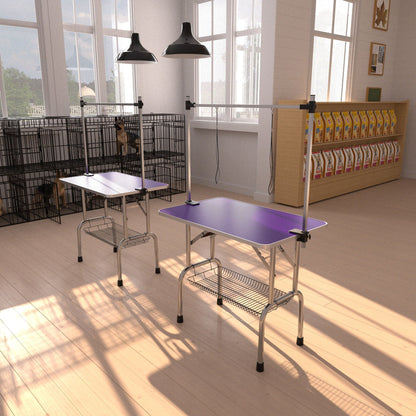 Folding dog grooming table with steel frame and purple rubber mat, adjustable arm clamps on Tampa Home & Garden Store