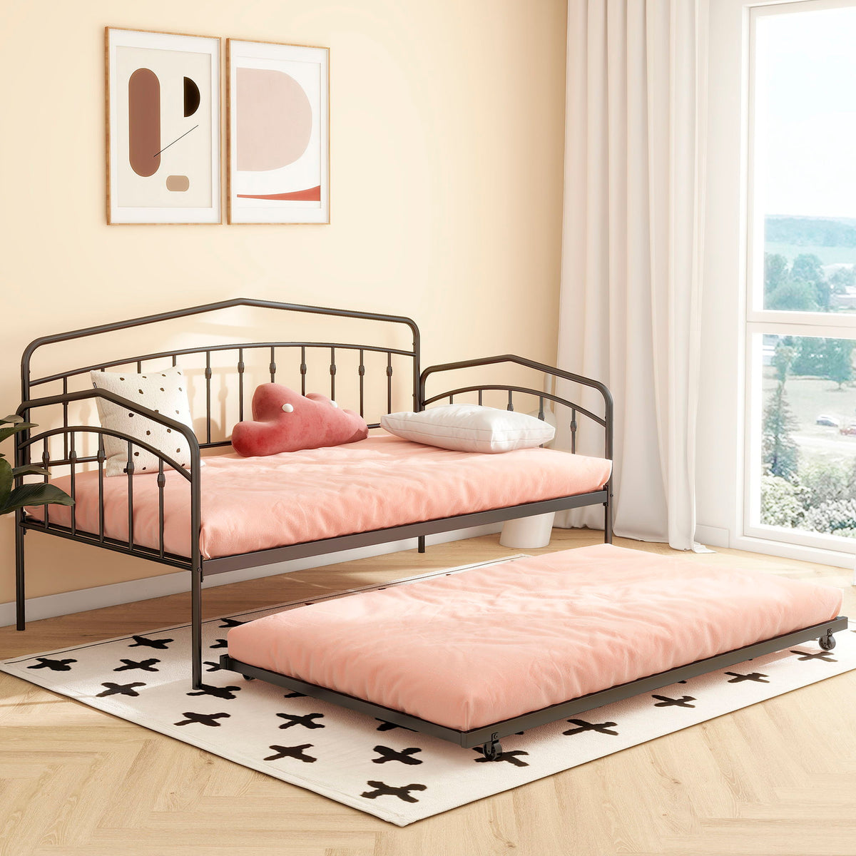 Two Fox daybeds with twin trundle in black metal frames and pink bedding in a bright room on Tampa Home & Garden Store