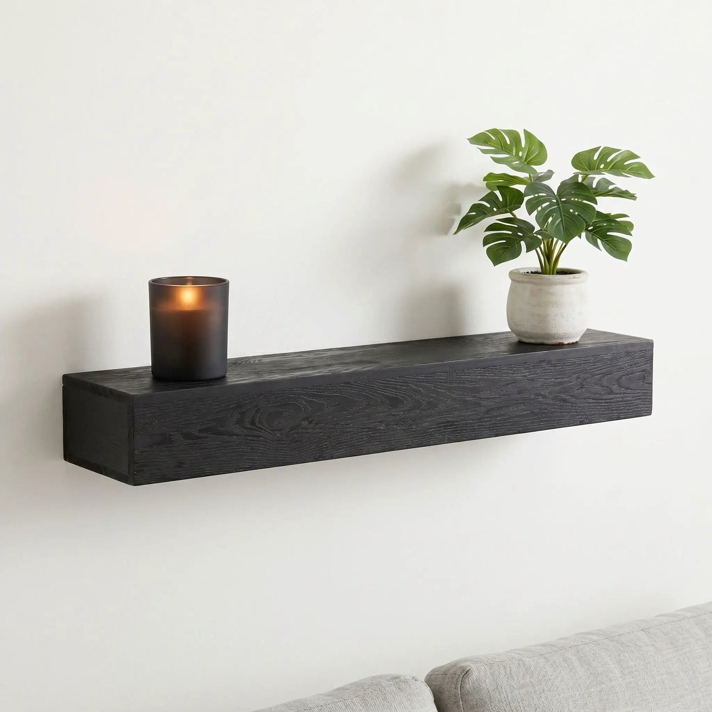48in embossed fireplace mantel wall-mounted black floating shelf with candle and monstera plant on Tampa Home & Garden Store