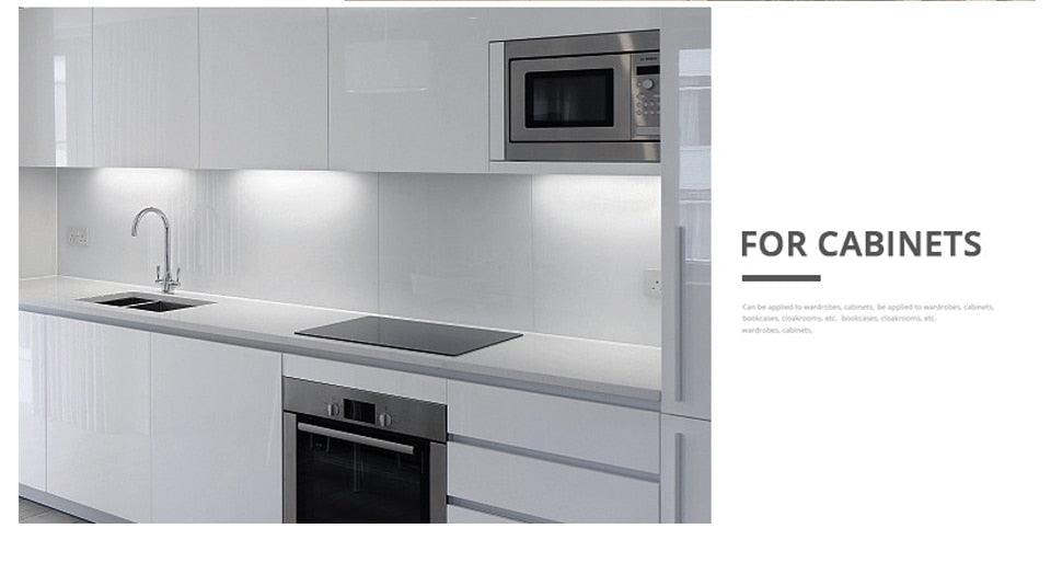 Under-cabinet LED strip lighting in a white kitchen with glossy cabinets on Tampa Home & Garden Store