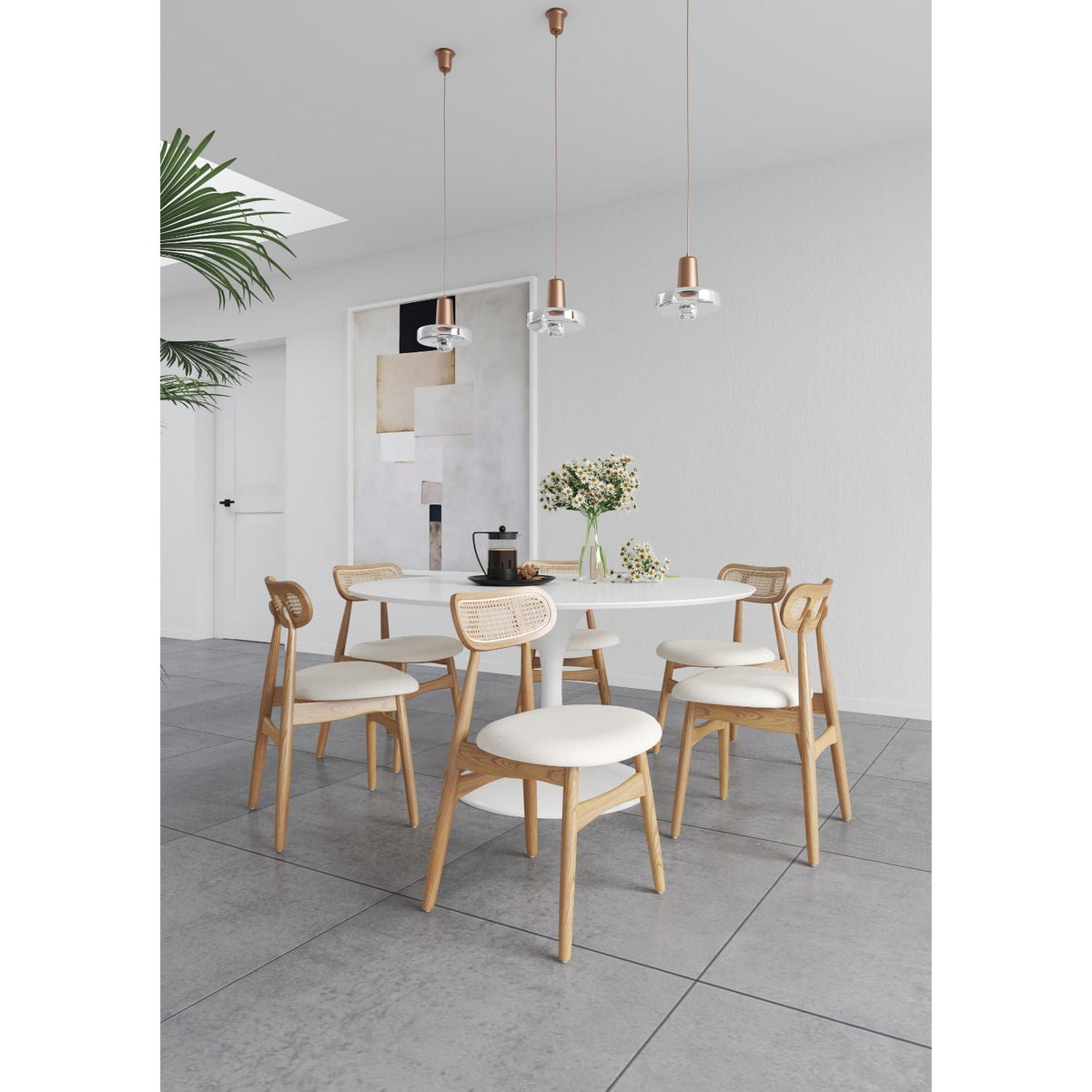 Dining chair set with cane backrests in light brown wood around a round white table on Tampa Home & Garden Store