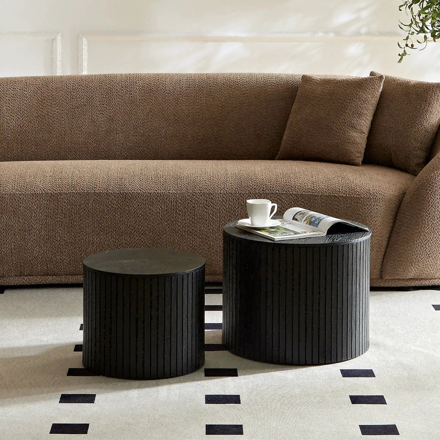 Handcrafted Nested Table Set, 2 Pieces; black round ribbed nesting tables beside a brown sofa on Tampa Home & Garden Store
