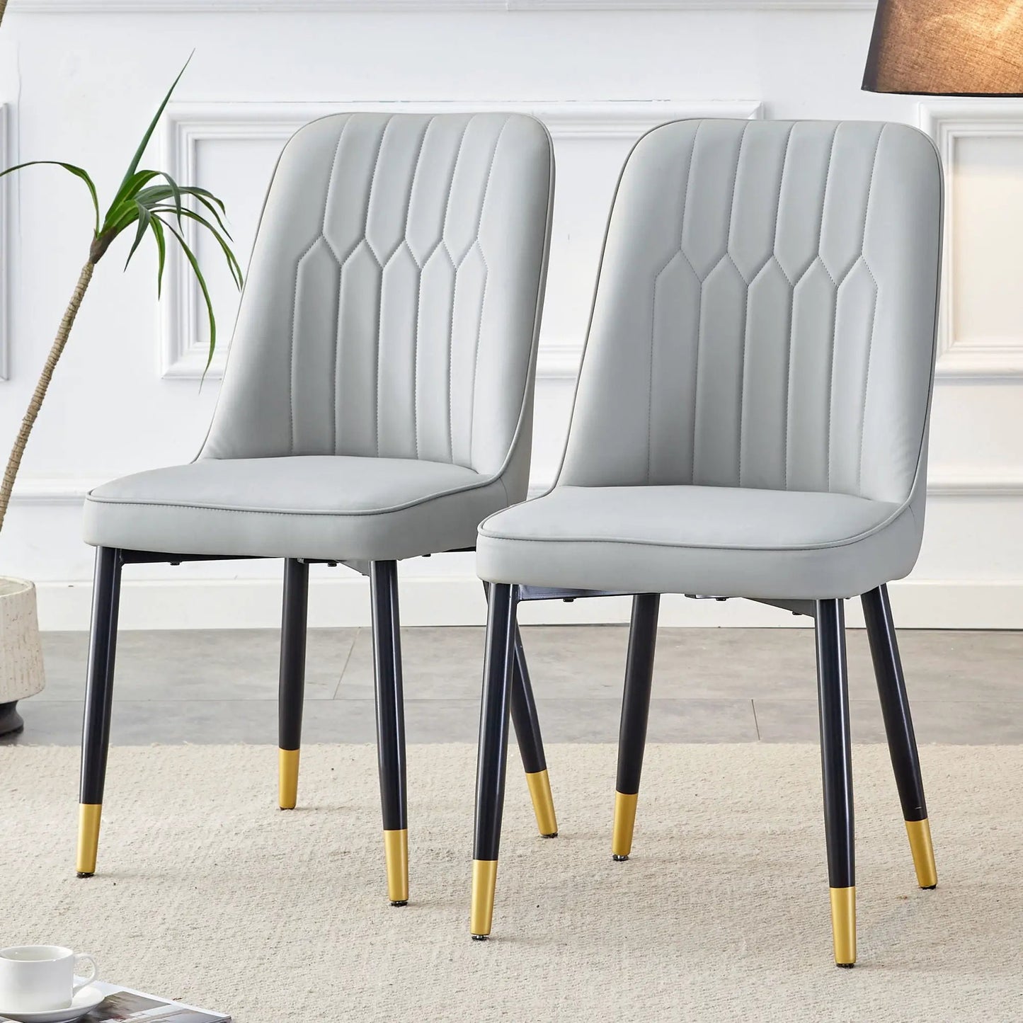 Modern chairs set of 2 with gray quilted upholstery and black legs with yellow tips on Tampa Home & Garden Store