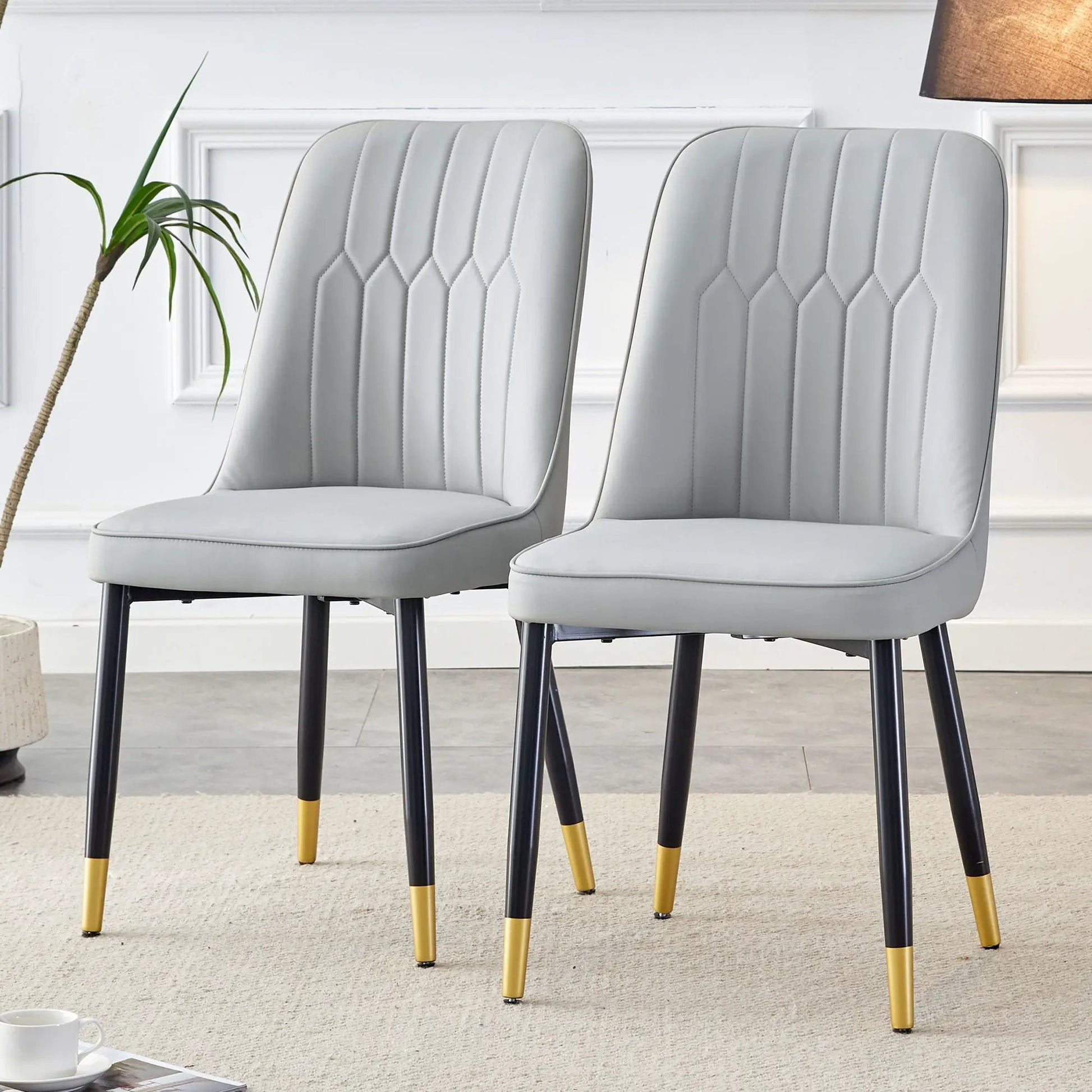Modern chairs set of 2 with gray quilted upholstery and black legs with yellow tips on Tampa Home & Garden Store