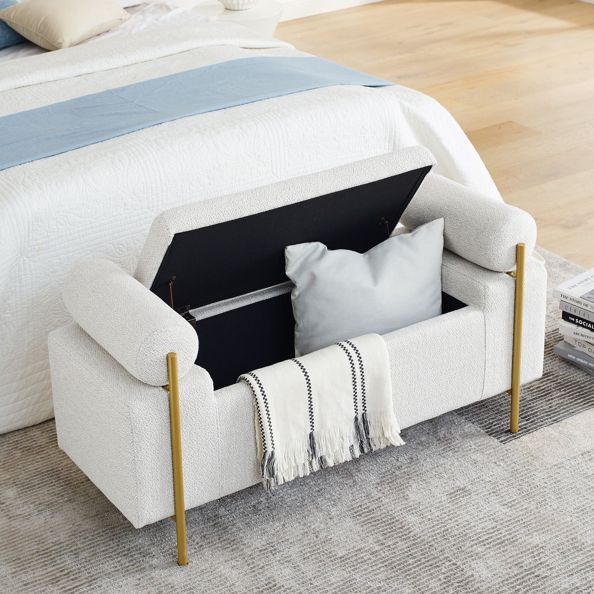 Elegant upholstered storage bench with light gray fabric, cylindrical arms and gold legs on Tampa Home & Garden Store