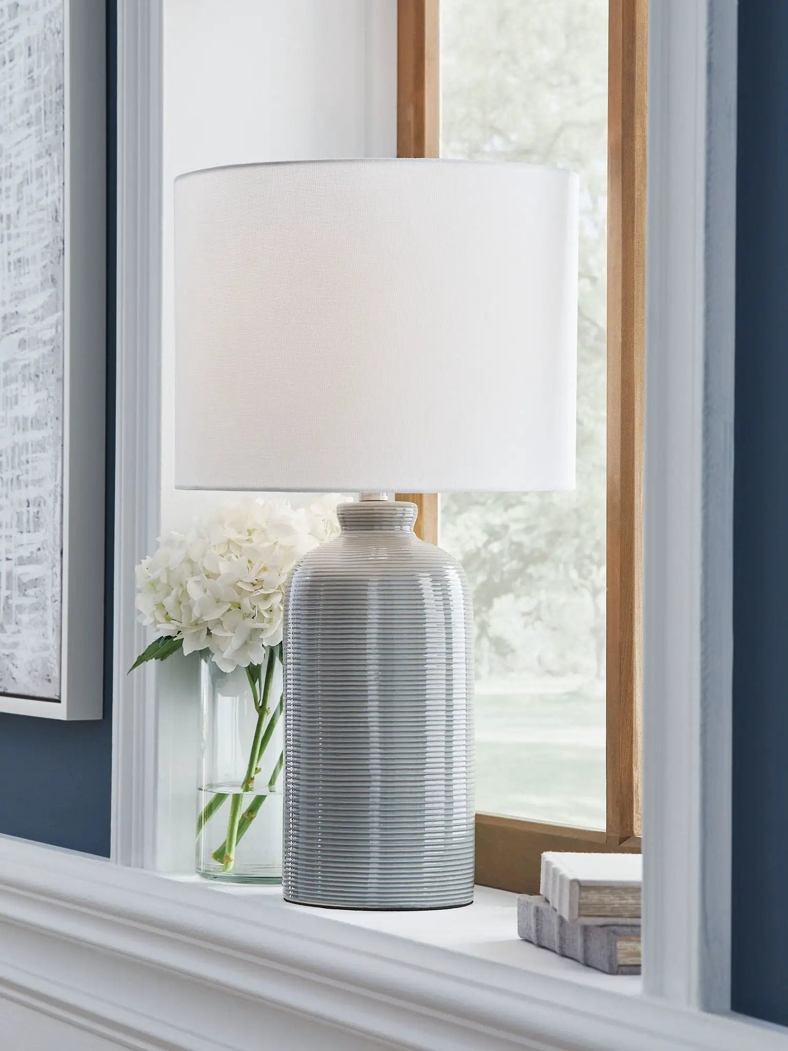 Wimlow ceramic table lamp gray-blue with ribbed base and white shade on windowsill on Tampa Home & Garden Store