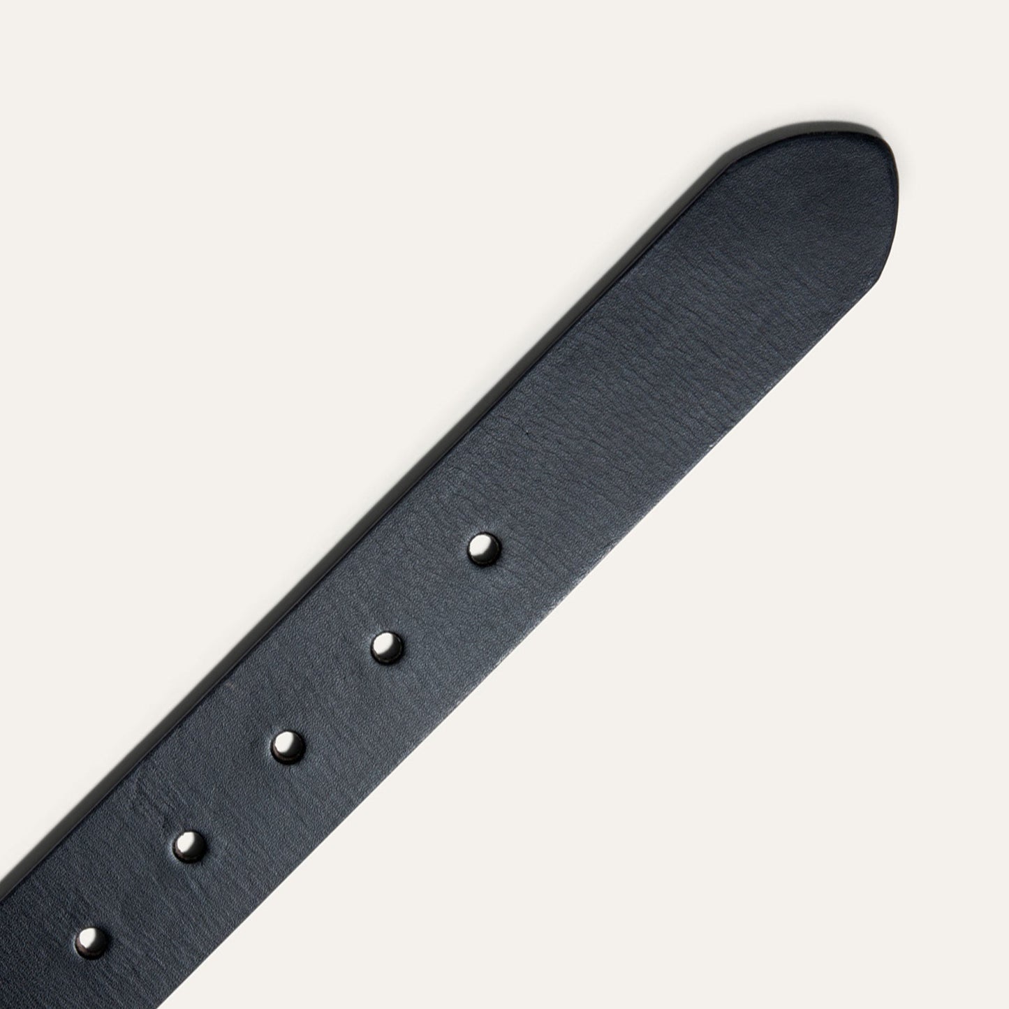 Black Edge Jean Belt in dark leather with silver rivets, close-up on Tampa Home & Garden Store