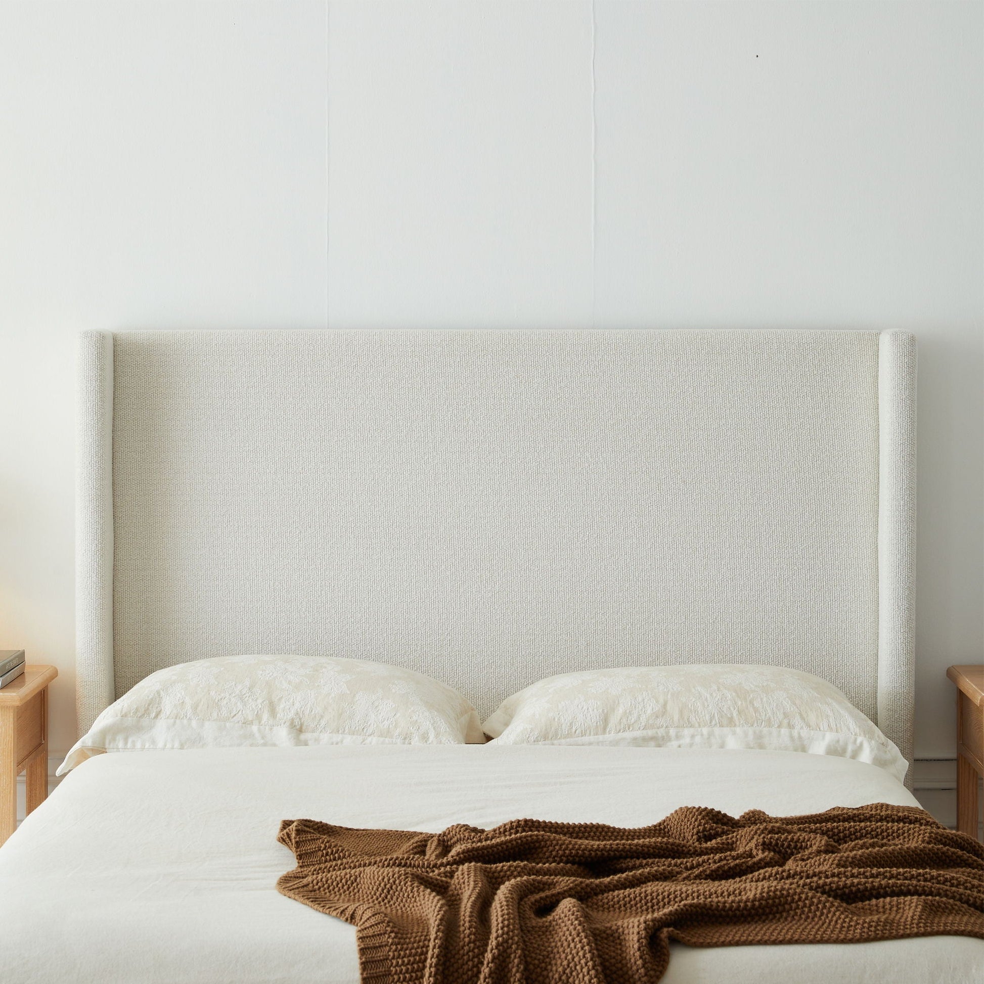 Hosford minimalist upholstered wingback bed with wood base platform in beige fabric on Tampa Home & Garden Store