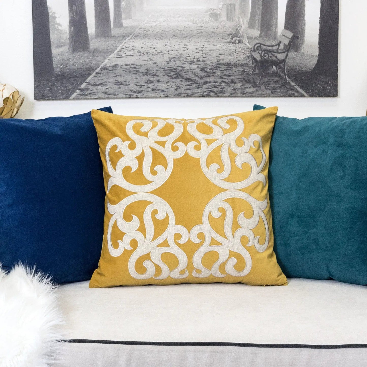 Dora pillow cover with matching back, yellow gold with scroll pattern, pillow on teal sofa on Tampa Home & Garden Store