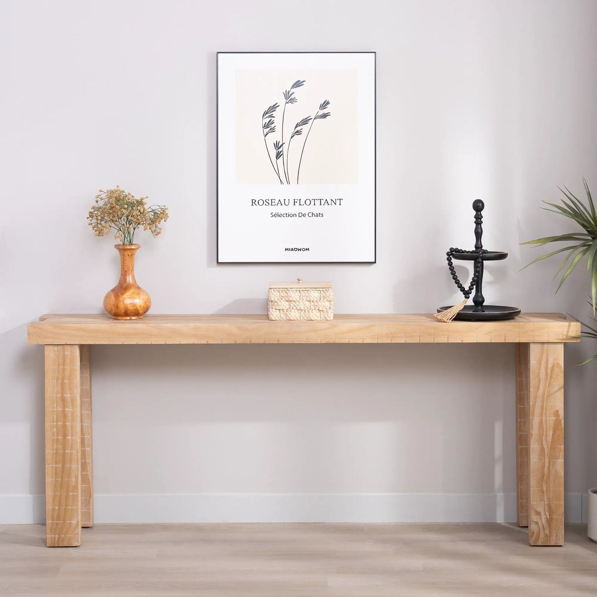 Console table with natural wood finish, long narrow profile, dried flower vase and framed art on Tampa Home & Garden Store