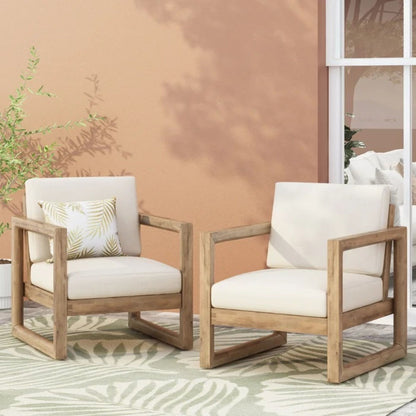 Pair of outdoor acacia wood patio club chairs by HouseOfZazla with cream cushions on Tampa Home & Garden Store