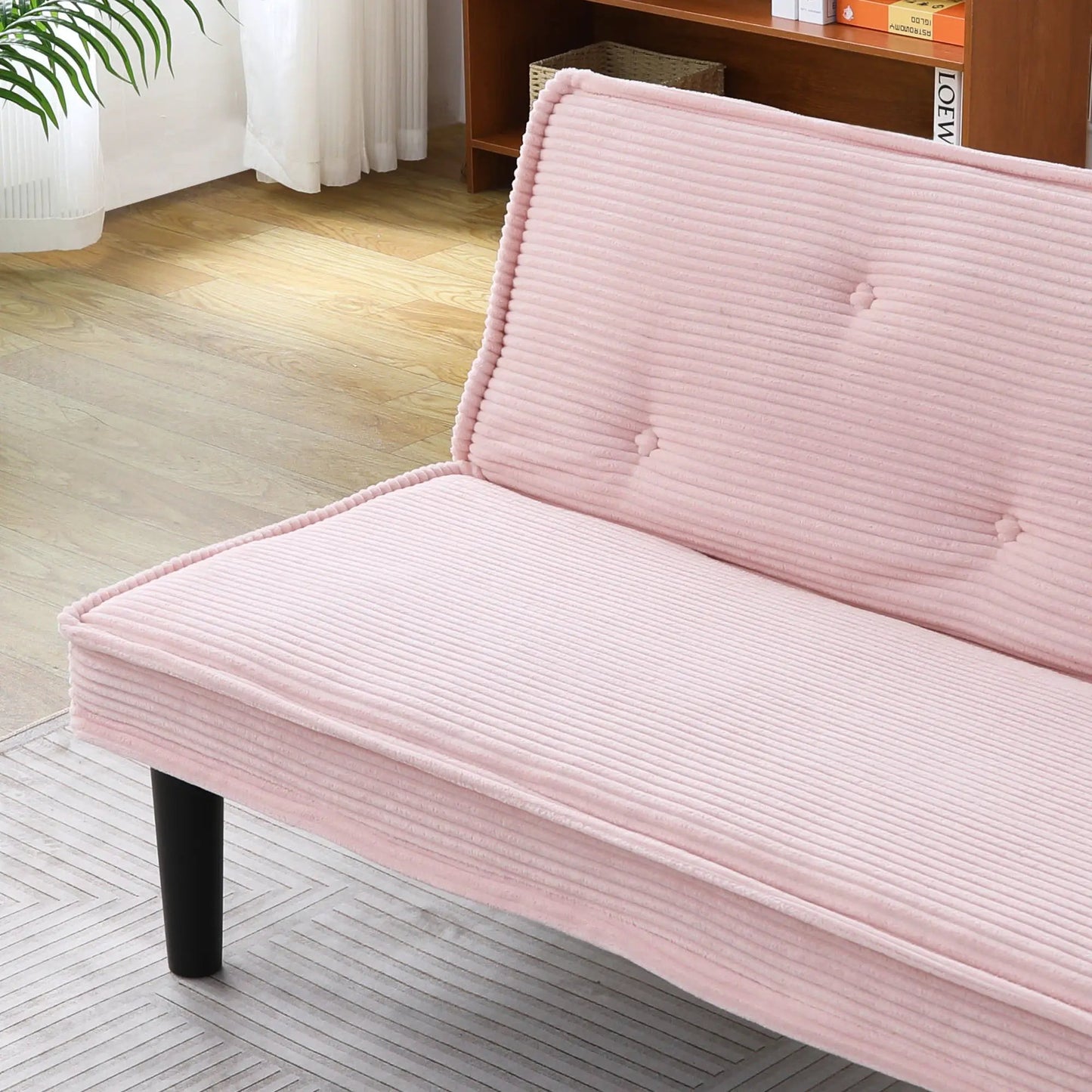 Versatile futon sofa with pink ribbed upholstery and solid wood frame on Tampa Home & Garden Store