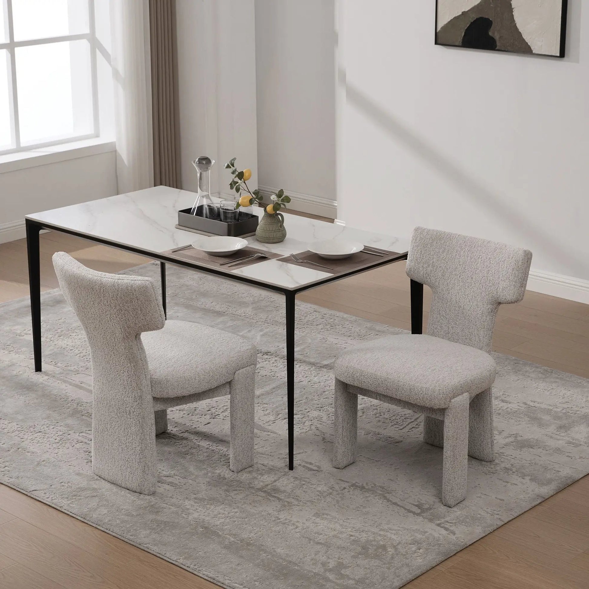 Armless curved-back accent chairs set of four in light gray fabric with black metal legs on Tampa Home & Garden Store