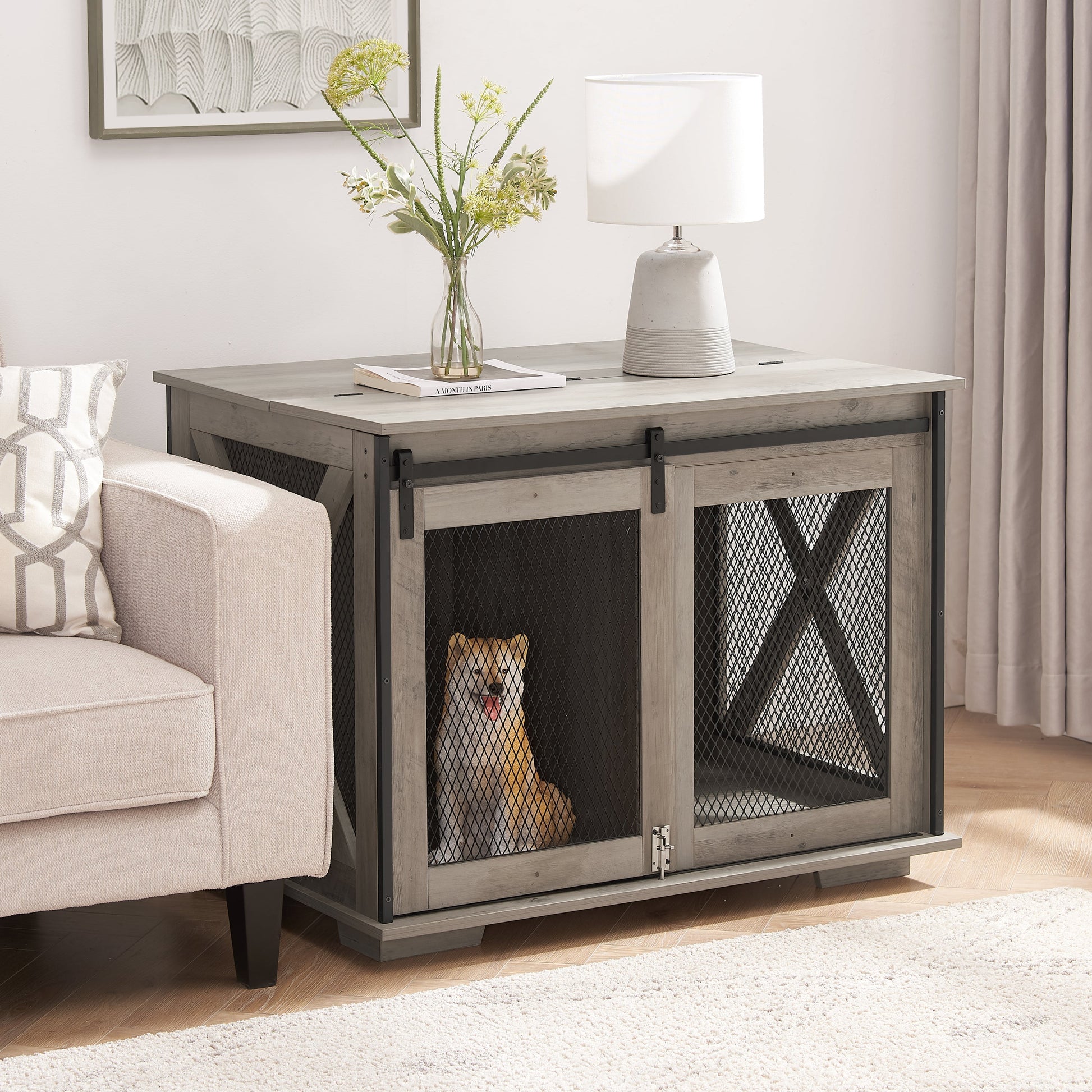 Farmhouse dog crate furniture with sliding barn door in gray wood and black mesh dog inside on Tampa Home & Garden Store
