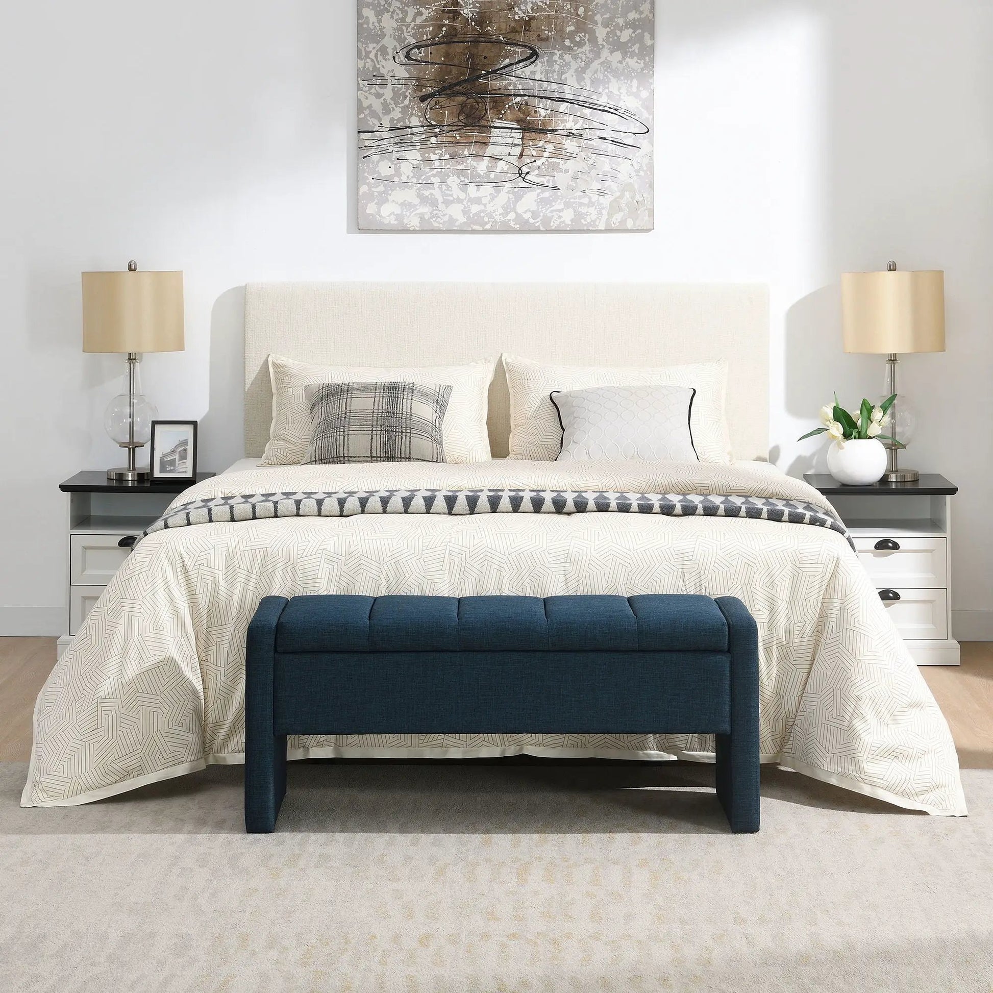 Modern upholstered bed end bench in deep blue at foot of beige bed in a chic bedroom on Tampa Home & Garden Store
