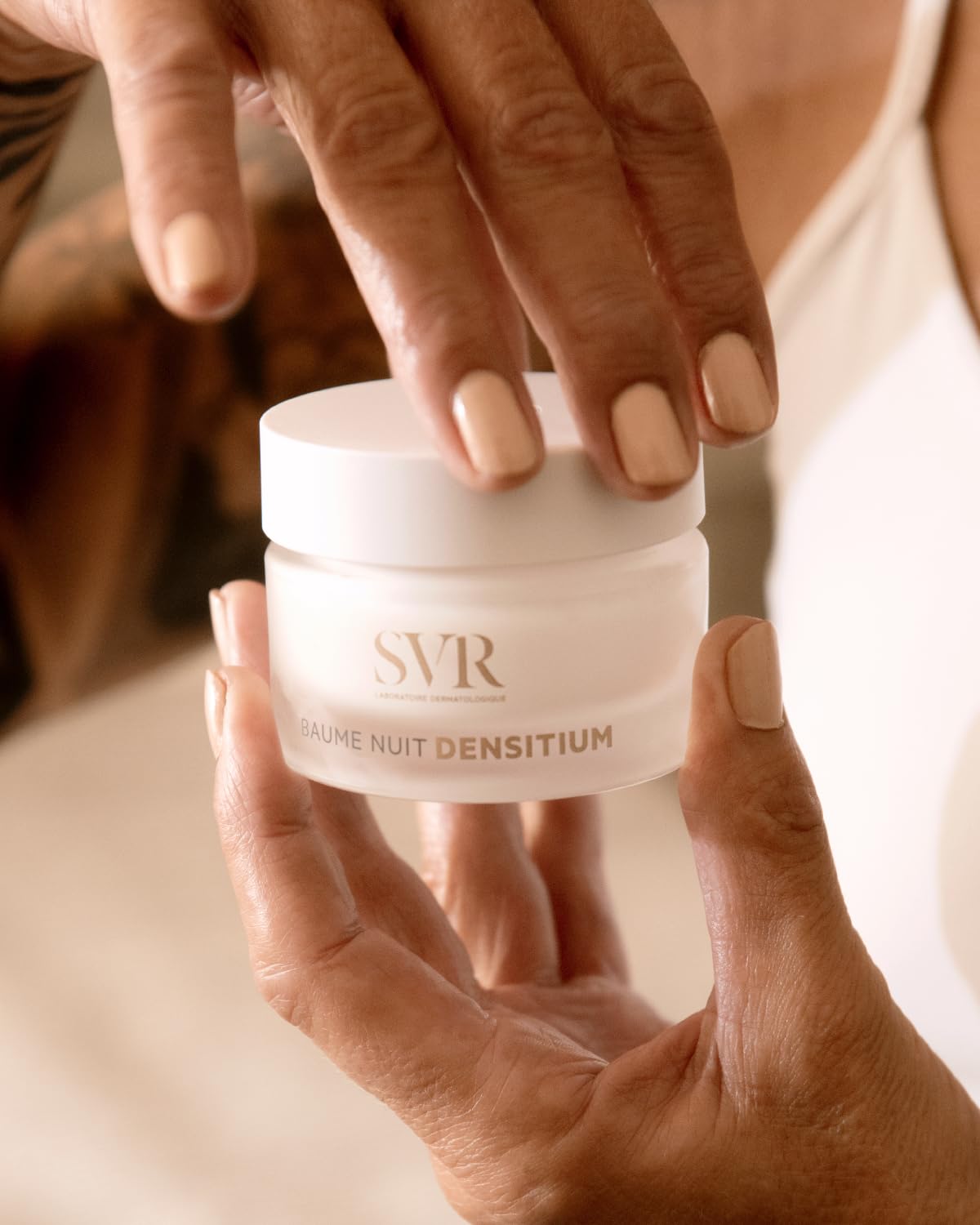 SVR Densitium night cream jar 50ml held by hands with nude nails, white frosted container on Tampa Home & Garden Store