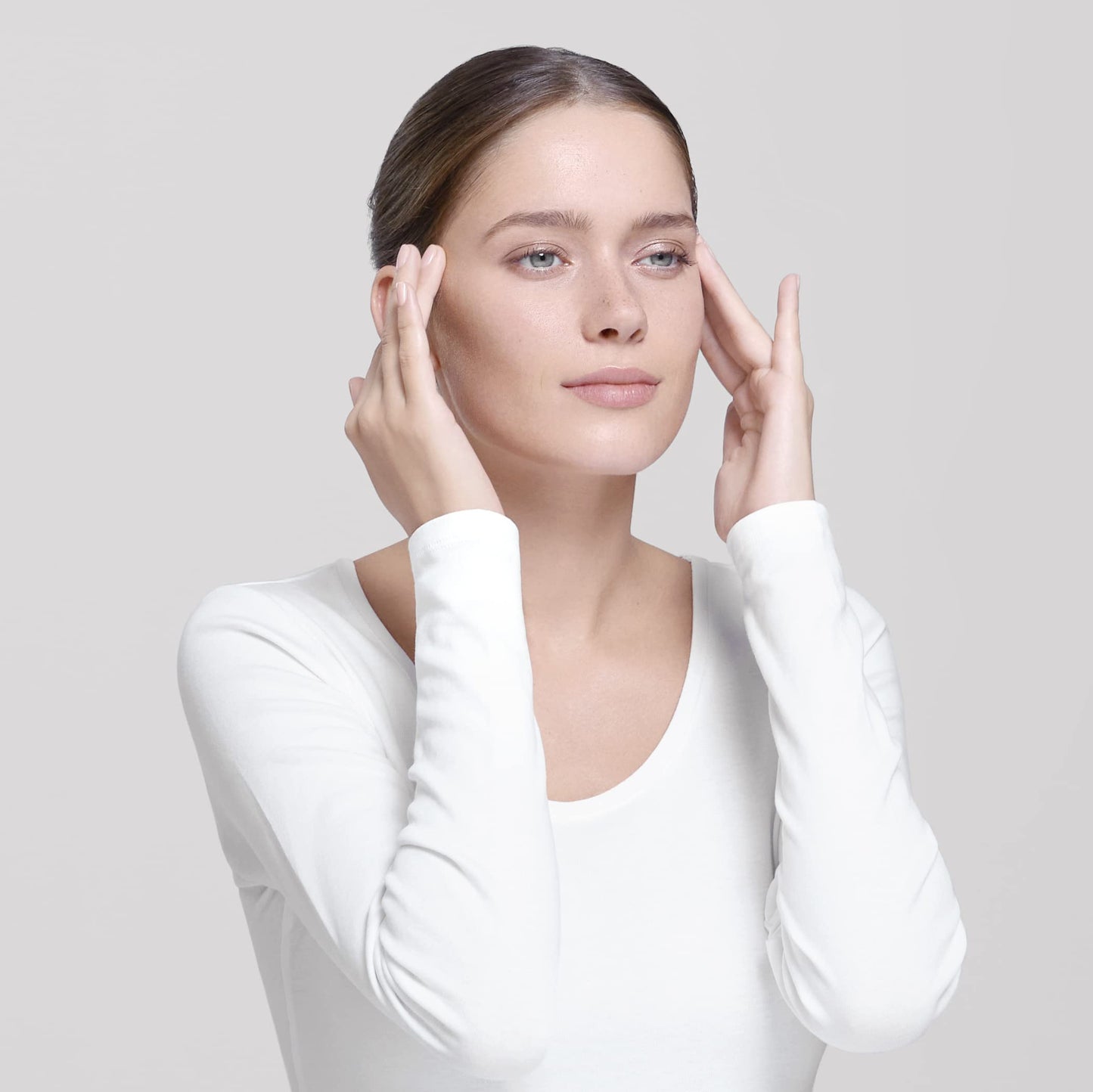 Esthederm Lift & Repair Instant Repulp Mask; woman with clear skin touching her cheeks on Tampa Home & Garden Store
