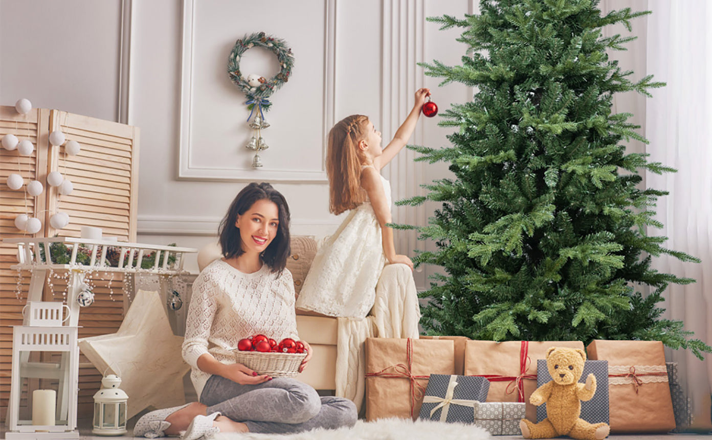 4FT Green PVC and PE Christmas Tree with 919 Tips by HouseOfZazla in a cozy living room with wrapped gifts on Tampa Home & Garden Store