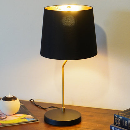Desk lamp with black shade and gold metal stem on a wooden desk on Tampa Home & Garden Store