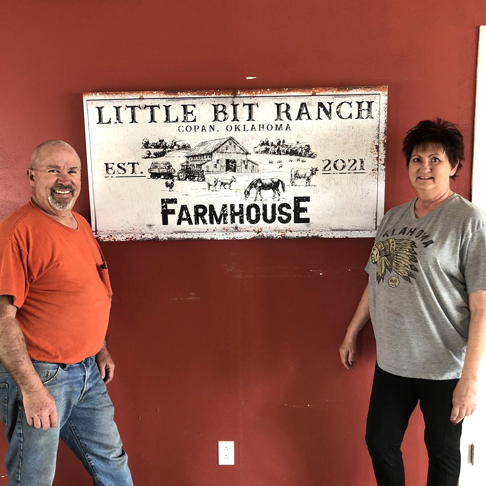Rustic Farmhouse Sign II canvas by Tailored Canvases, people beside distressed sign on red wall on Tampa Home & Garden Store