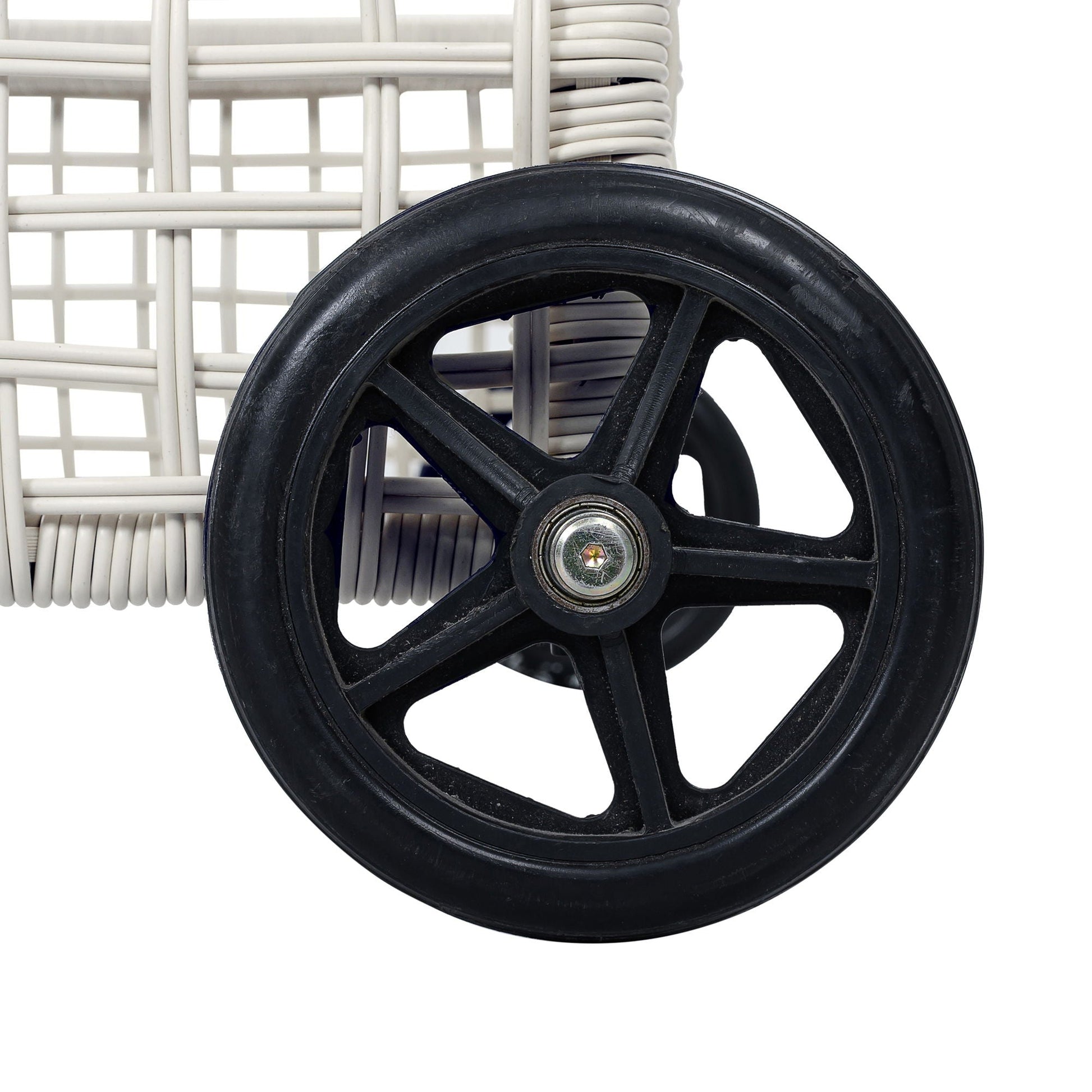Outdoor chaise wheel close-up with a black wheel beside white wicker sunlounger frame on Tampa Home & Garden Store