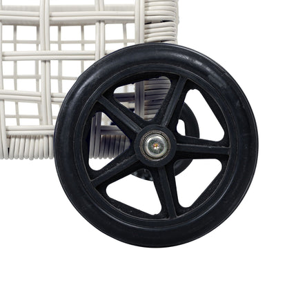 Outdoor chaise wheel close-up with a black wheel beside white wicker sunlounger frame on Tampa Home & Garden Store
