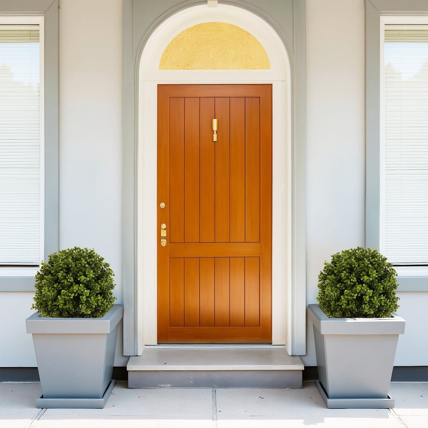 Set of 2 green artificial boxwood ball topiaries in gray planters flanking a front door on Tampa Home & Garden Store