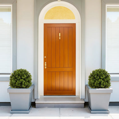 Set of 2 green artificial boxwood ball topiaries in gray planters flanking a front door on Tampa Home & Garden Store