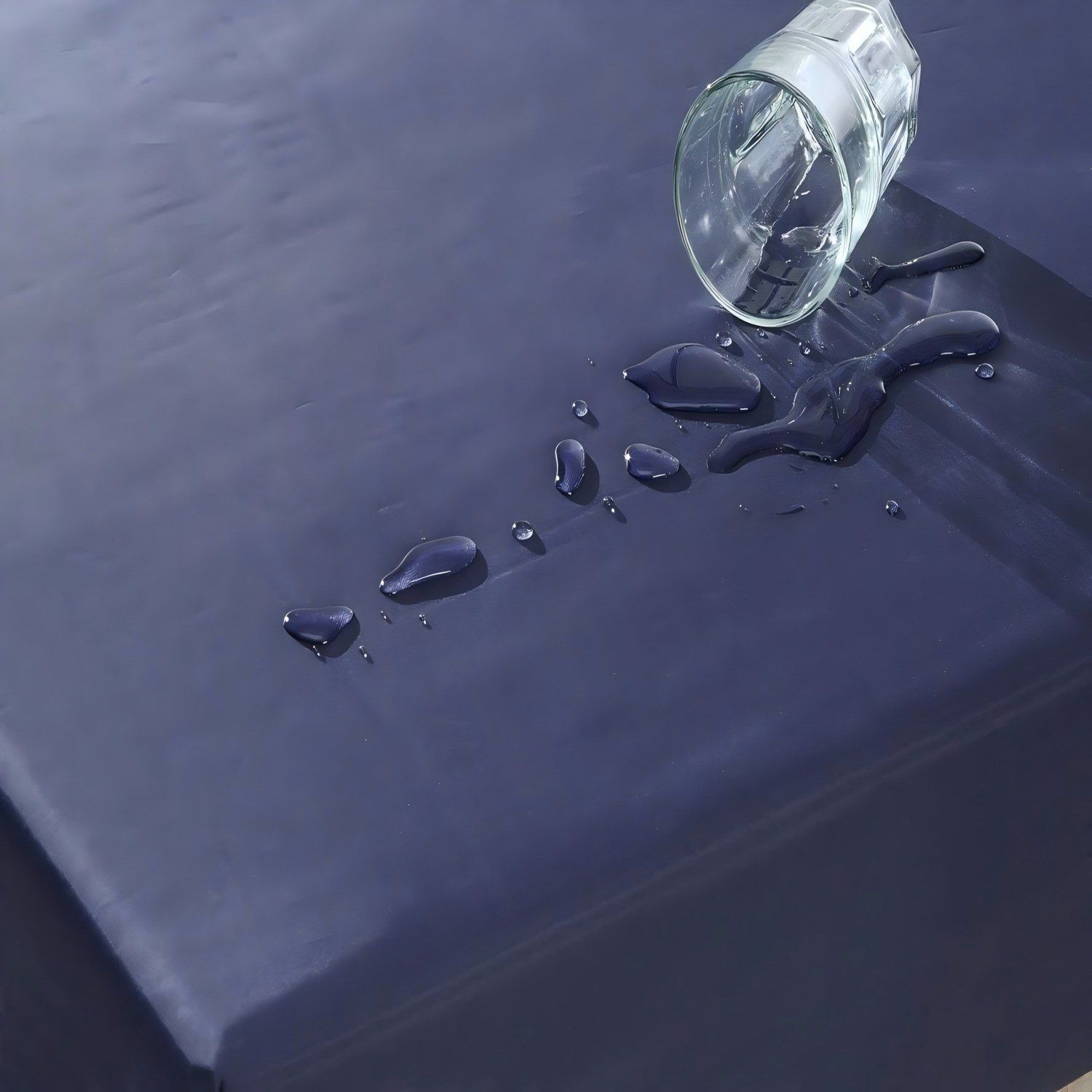 Glass jar spilled on a dark blue surface with scattered blue liquid droplets HouseOfZazla on Tampa Home & Garden Store